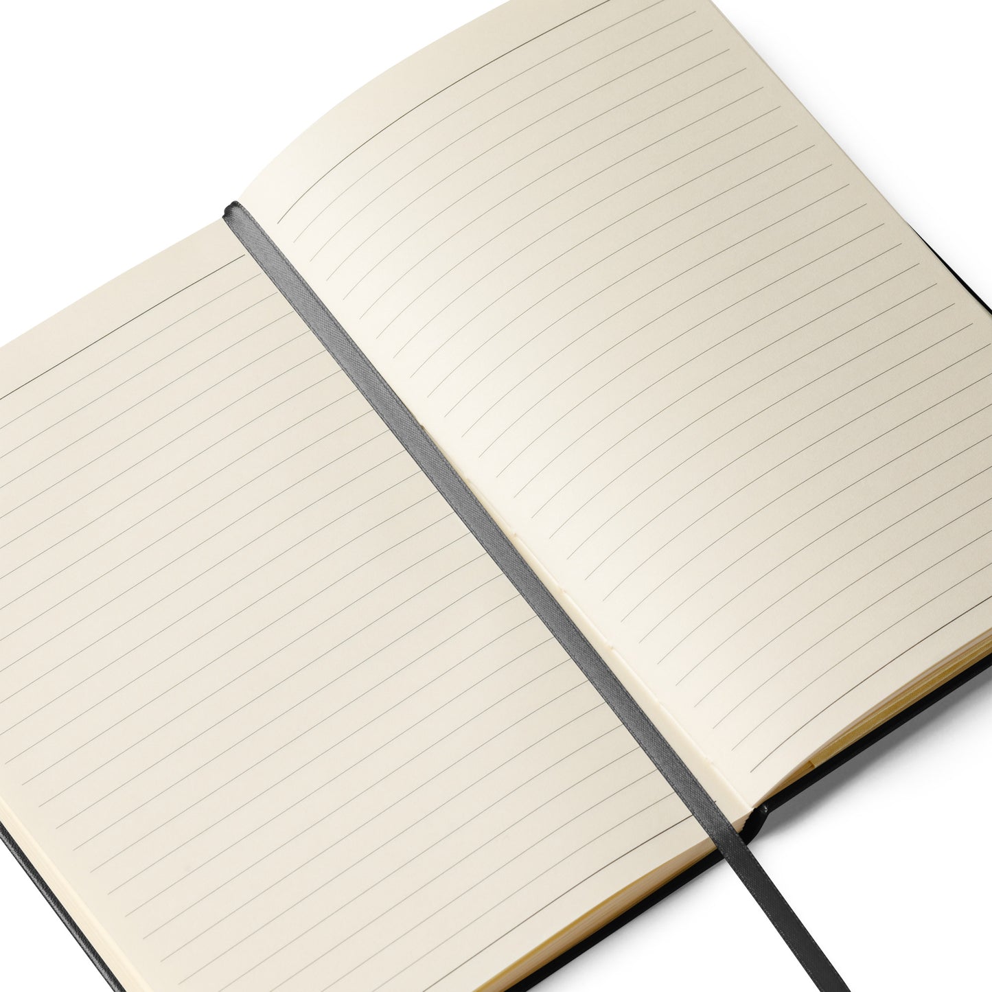 Lined paper of the notebook opened up in the middle with the flat black fabric strip book mark